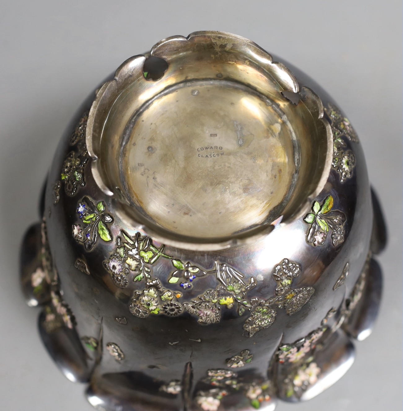 An early 20th century Japanese white metal fruit bowl with applied enamelled foliate decoration(a.f.) diameter 18.9cm, gross 14.2oz.